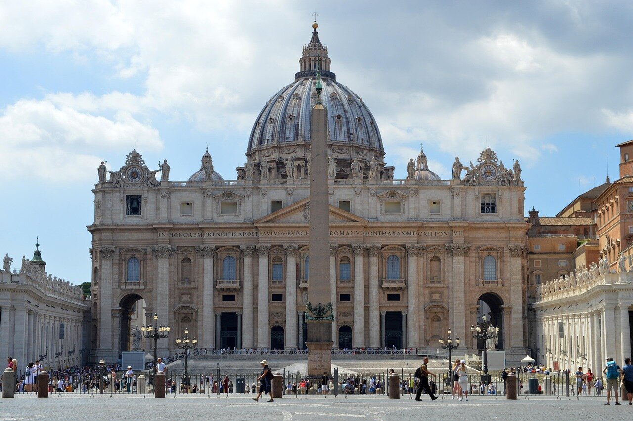 A historic Church building serves as the backdrop for ongoing debates about governance and doctrine, symbolizing the struggles faced by the Catholic Church today