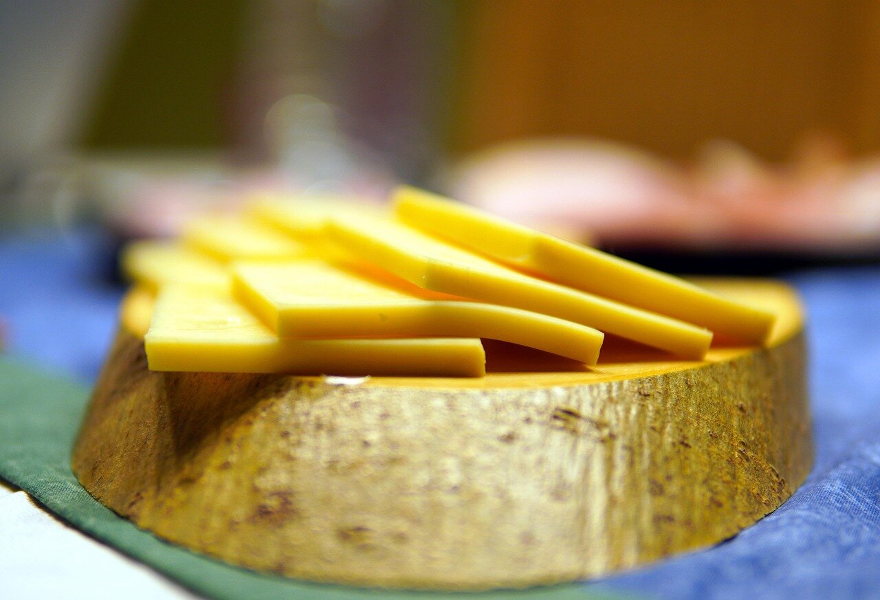 A group of remote workers gathers around a table in a bright office space, discussing strategies to enhance productivity while enjoying healthy snacks.