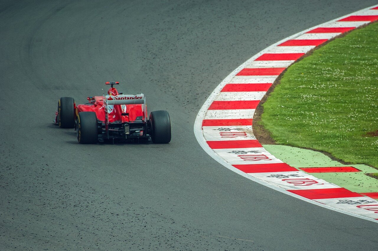 Lewis Hamilton speaks with a team engineer about the impact of new car designs on racing strategies during a practice session at Silverstone.