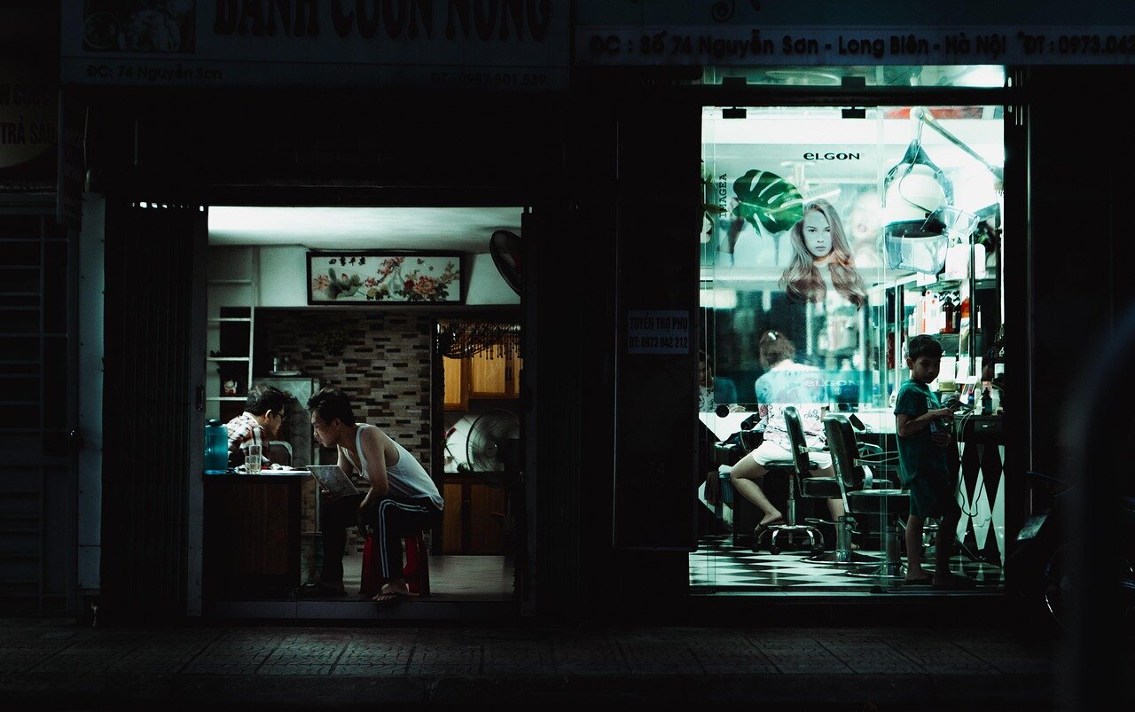 A group of passionate gamers gathers at a local arcade, discussing the recent backlash against Sony's decision to region lock Marvel Tōkon Fighting Souls, while some hold signs advocating for a more accessible gaming community.