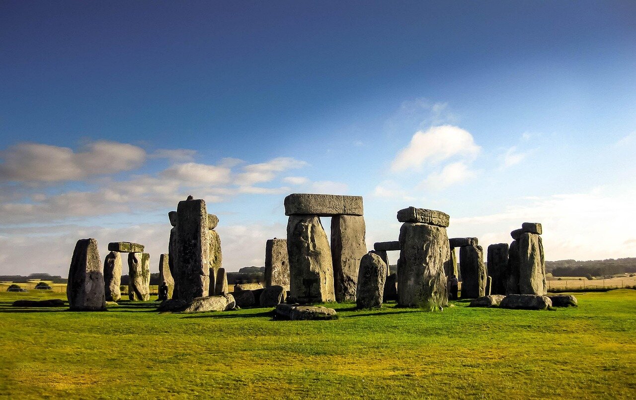 A sweeping view of the surrounding landscape, showcasing the proximity of the simpler version of Stonehenge to the iconic stone structure