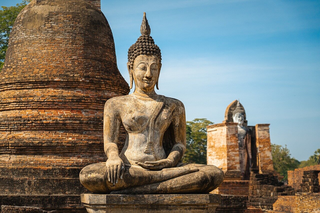 A serene Buddhist temple surrounded by flowers and offerings, symbolizing the monks' revered status and the community's loss